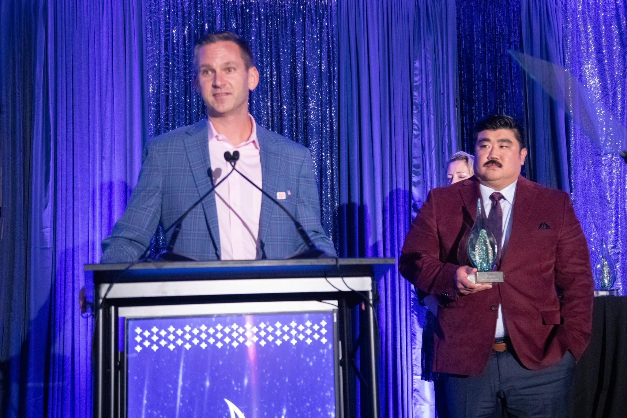 Travis Stoliker accepting Greater Lansing Business of the Year award
