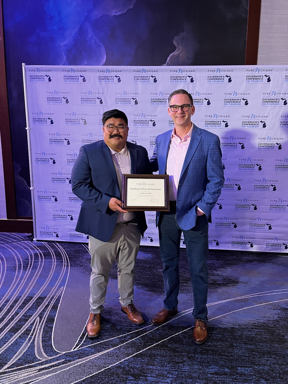 Travis Stoliker and Matthew Gillett at Pure Michigan Governor's Conference on Tourism receiving Certificate of Pure Achievement